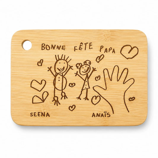 Planche à découper en bambou personnalisée avec dessin d’enfant gravé, message Bonne fête papa, cœurs et empreinte de main.